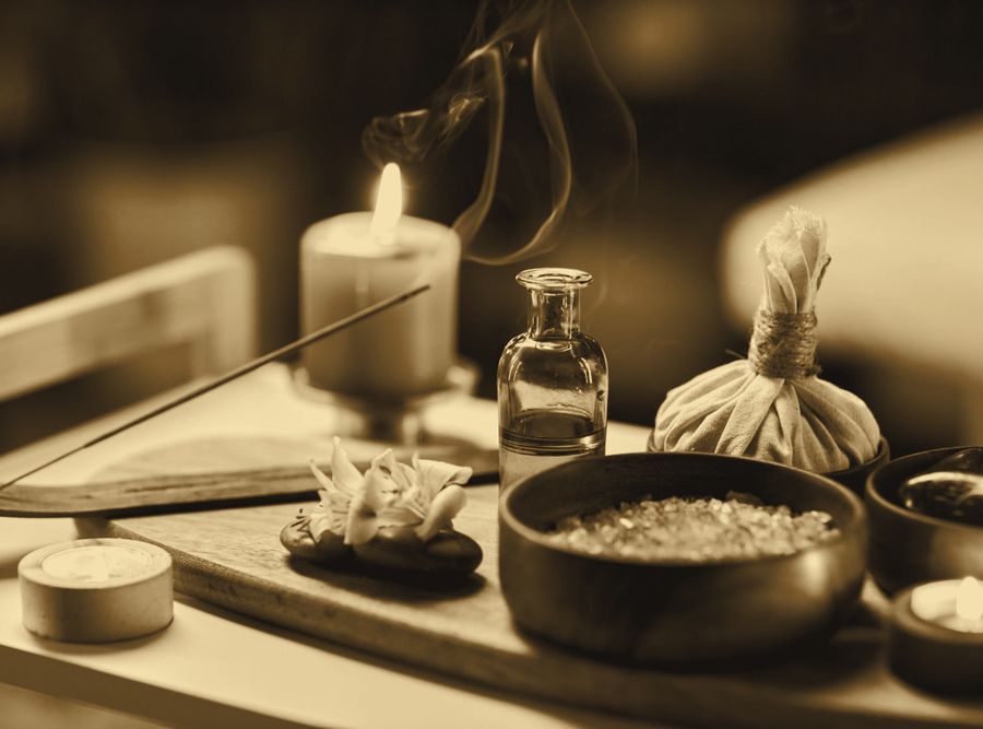 Massage oils and herbal ball laid out in a Nallagandla spa room